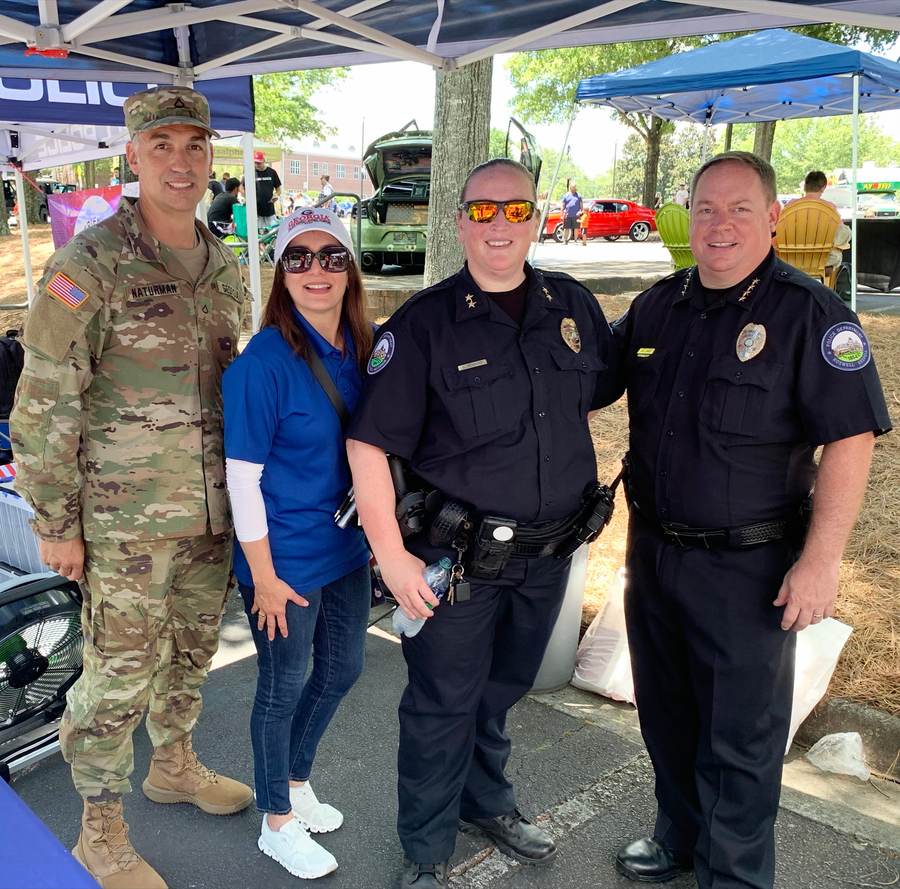 A Roswell Police chief, officer, volunteer, and U.S. Army soldier at a Roswell community expo.