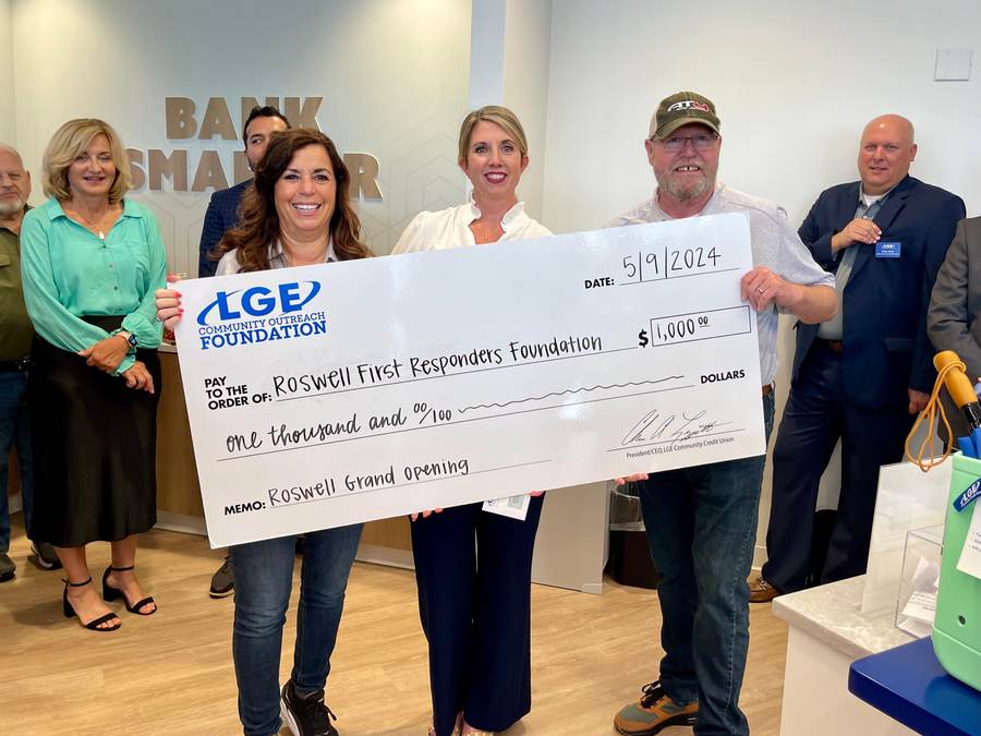 Roswell Police and RFRF accept an LGE Community Outreach Foundation check.