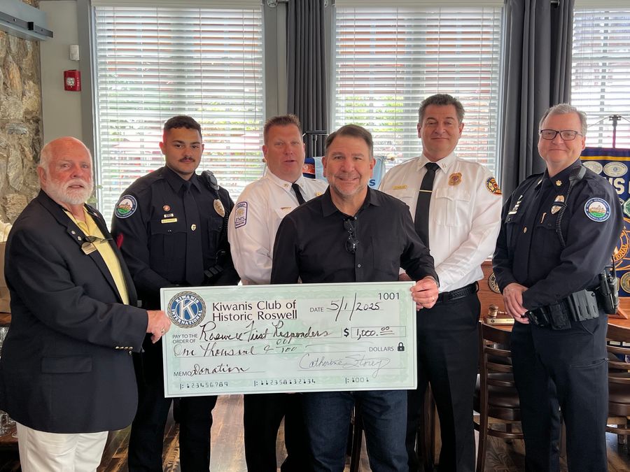 Roswell Police command staff receive a Kiwanis Club of Historic Roswell donation for RFRF.