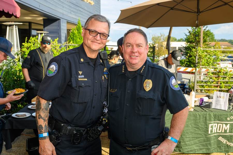 Roswell Police command staff visiting neighbors at the From The Earth Brewing fundraiser.