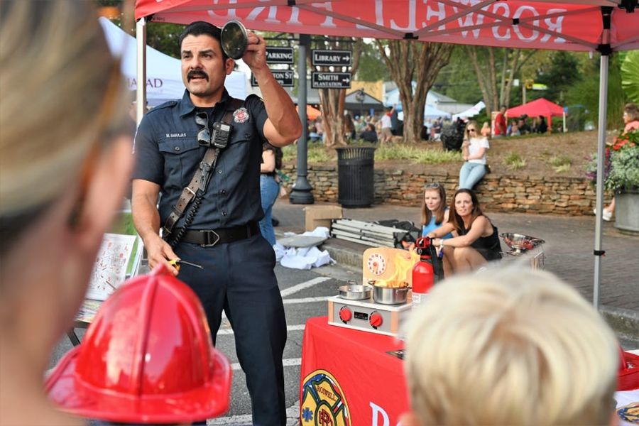 A Roswell firefighter waves to the crowd at Alive Roswell.