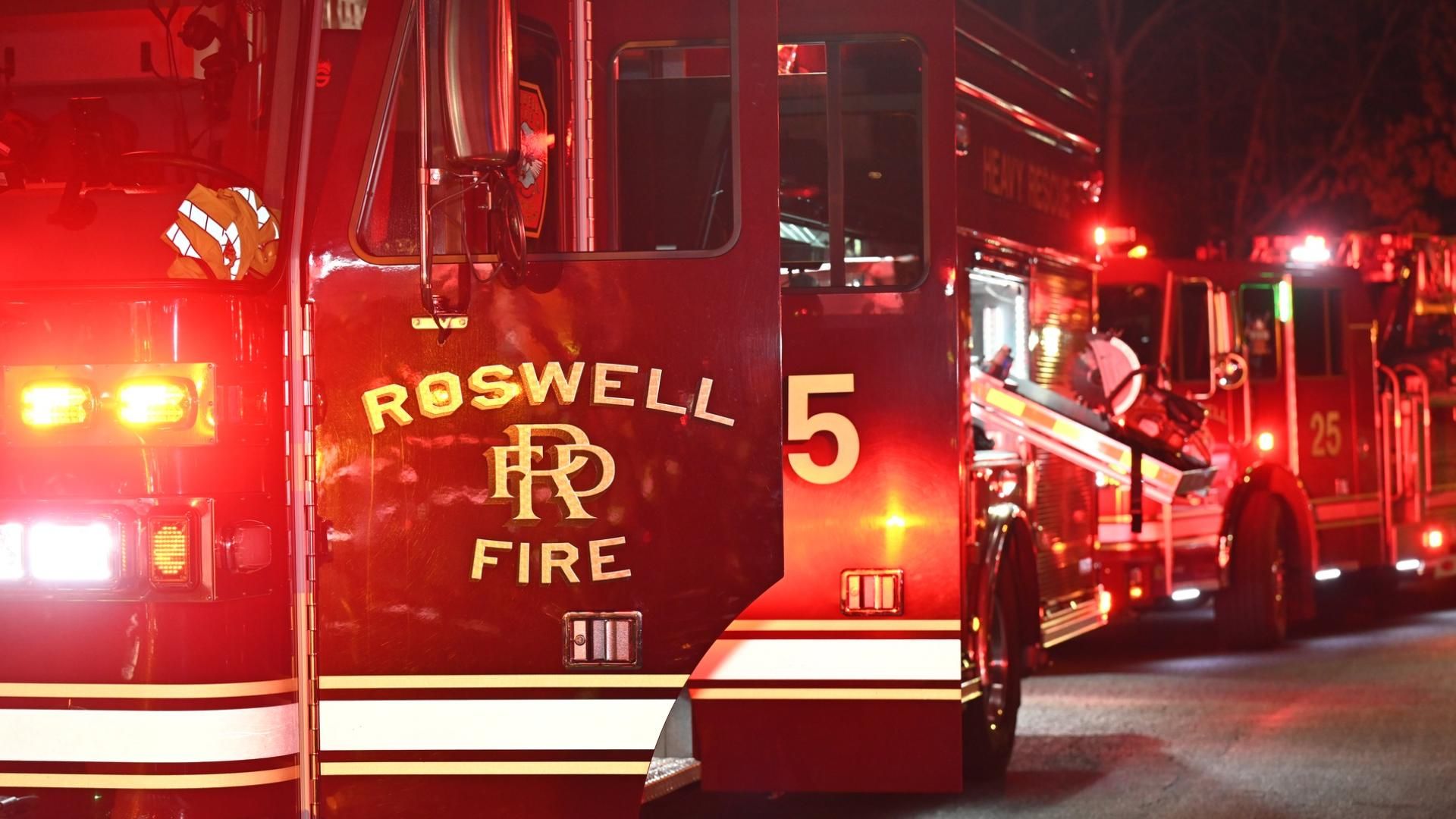 Roswell Fire Department truck illuminated at night.